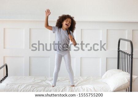 Similar – Image, Stock Photo Little girl singing dancing imitating herself a real singer