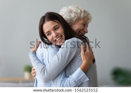 Similar – Image, Stock Photo Two happy affectionate young woman hugging each other in a close embrace while laughing and smiling, young multiracial female friends