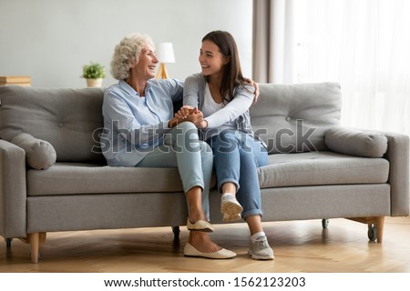 Image, Stock Photo Grandchildren teenage girl and her younger sister talking on video call with granparents on laptop from home during COVID-19 quarantine. Girls sitting on bed in front of computer