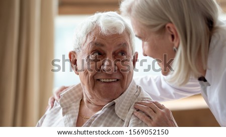 Similar – Image, Stock Photo Indoor shot of pleasant looking curly woman has pleasant smile, makes okay gesture, excellent sign, gives approval, dressed in fashionable leather shirt, isolated over brown wall, blank space on left