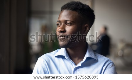 Head shot close up young thoughtful african american businessman entrepreneur looking away. Pensive mixed race confident international company employee manager thinking of problem solution at office.