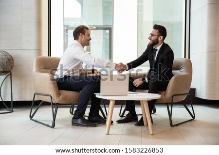 Image, Stock Photo Ethnic happy businessman shaking hands with partner and looking at camera