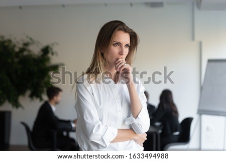 Lost in thoughts business lady entrepreneur standing in office feels concerned thinking of new challenges solving problems. Stressed woman applicant feels anxious about failed job interview concept Foto d'archivio © 