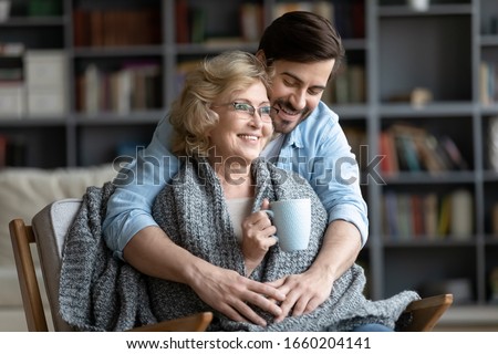 Similar – Image, Stock Photo Young man taking care of his plants on a balcony