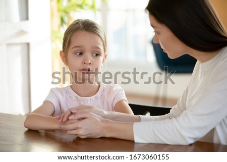 Similar – Image, Stock Photo Compassionately, the little girl sits at home, with the broken doll, in the sunlight.