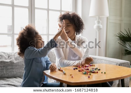 Similar – Image, Stock Photo Two schoolgirls spending time in school library. Primary school students learning from books. Children having fun in school club. Doing homework