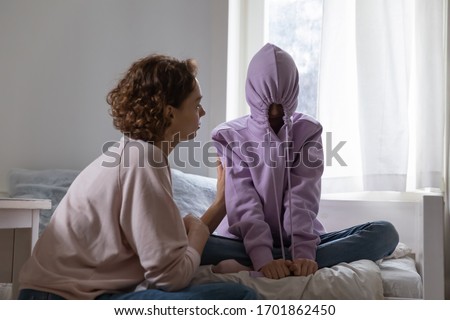 Similar – Image, Stock Photo Teenager with hoodie in front of a dotted concrete wall