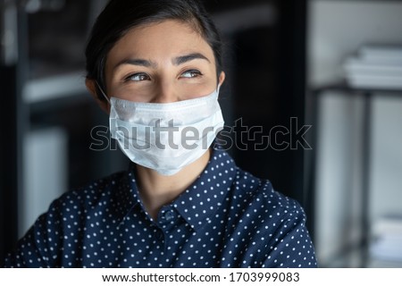 Similar – Image, Stock Photo Corona Thoughts | The evening sun illuminates a green area with trees and a parking lot in front of a row of houses in the background, which is closed off by a red and white fluttering band