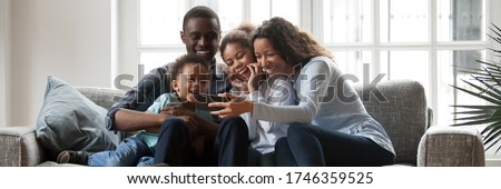 Similar – Image, Stock Photo Cheerful ethnic couple taking selfie in park