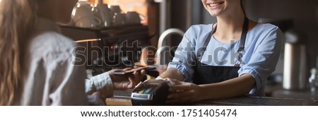 Customer stand near bar counter pay bill using cell application and pos machine. Mobile payment apps advertisement, smartphone is your wallet concept. Horizontal photo banner for website header design