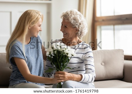 Similar – Foto Bild Frau mit Blume auf einem Pflaster