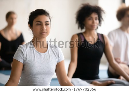 Similar – Image, Stock Photo Young woman with intense green eyes looks at camera