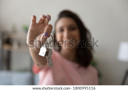 Crop close up of female tenant renter show praise house keys moving to first own new apartment or house, happy woman owner buy purchase home, relocate to dwelling, rental, rent, ownership concept Stockfoto © 