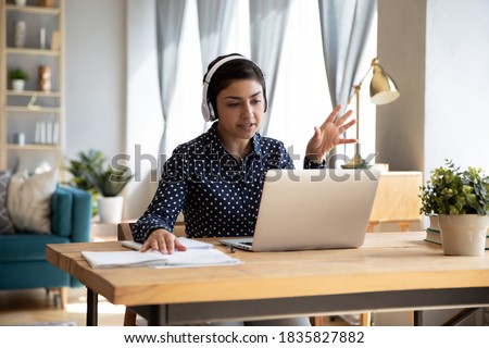 Video call communication lead indian leader talk to colleagues work from home office wear headphones express opinion offer solution at virtual meeting. Student use pc and internet e-learning remotely