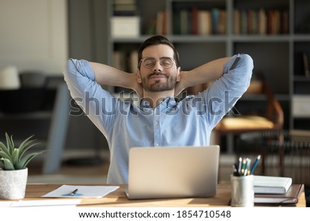 Relaxed man take break from work put hands behind head lean on comfy chair closing eyes feels serenity, enjoy fresh conditioned air in modern office, no stress, fatigue relieve at workplace concept