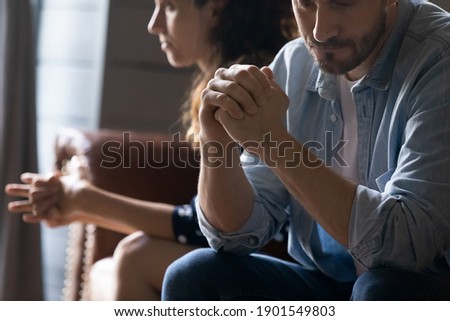 Crop close up of unhappy young couple sit separate have problems in relationship think of breakup or divorce. Upset man and woman family lovers avoid talking suffer from cheating in relation troubles.