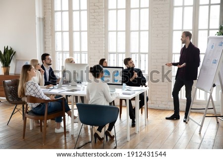 Manager presenting sales report to office colleagues. Leader giving presentation to employees at corporate meeting. Business coach training staff. Workshop, presentation concept