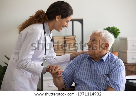 Thank you doctor. Smiling thankful mature sick man holding young female medic nurse hand appreciating for help support care. Happy woman gp greeting old man patient with recovery good analyses results
