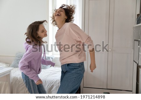 Similar – Image, Stock Photo Two schoolgirls spending time in school library. Primary school students learning from books. Children having fun in school club. Doing homework