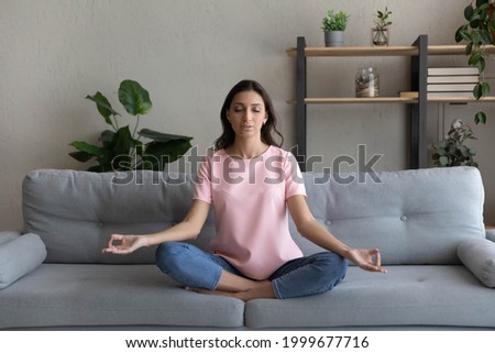 Similar – Image, Stock Photo Peaceful Arab woman doing yoga on embankment