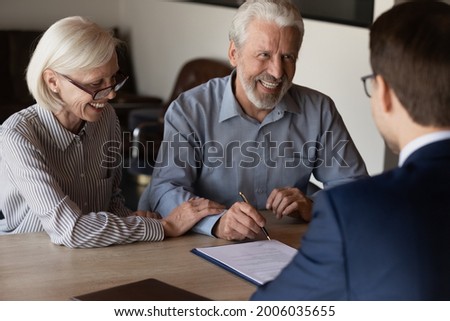 Happy mature family couple of clients consulting legal expert, lawyer, solicitor about legal document signing, asking advice, question, talking, celebrating deal, house or medical insurance buying ストックフォト © 