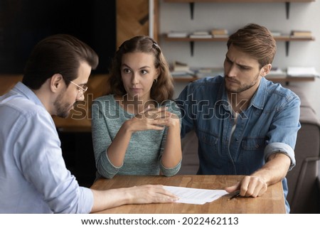 Couple of angry tenants having dispute with real estate agent, discussing complaint with lawyer, consulting legal expert about mistakes in document, wrong mortgage agreement. Cheated clients concept Stock foto © 