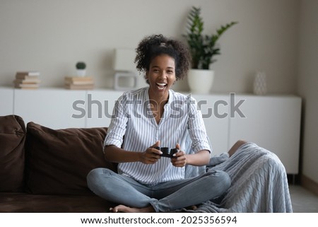 Similar – Image, Stock Photo Cheerful women playing videogame on couch