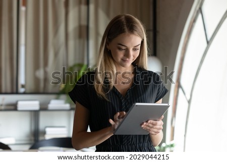 Smiling young Caucasian woman employee sue tablet consult communicate with business client or customer online. Female businesswoman hold pad device talk speak on video webcam call on gadget. Stock foto © 