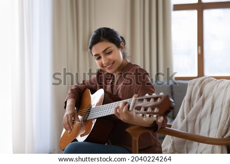 Similar – Image, Stock Photo Calm woman playing guitar in bedroom