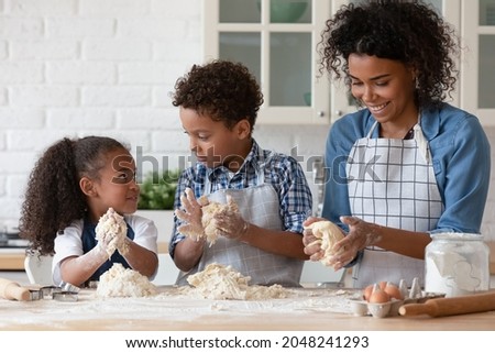 Similar – Image, Stock Photo Siblings kneading dough in kitchen