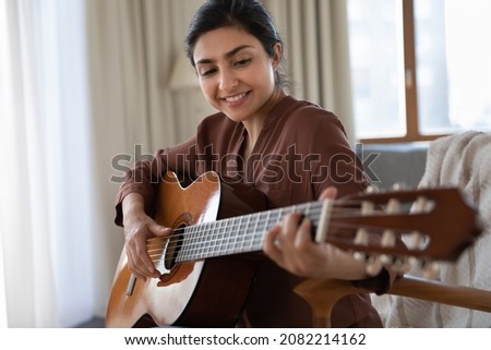 Similar – Image, Stock Photo Positive woman playing guitar in bedroom