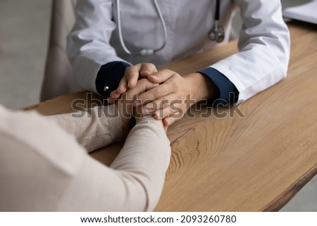 It will be all right. Close up view of female doctor gp hands hold caress palms of woman patient. Young lady general practitioner therapist physician comfort sick person give hope support care belief 商業照片 © 