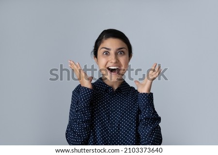 Excited happy young Indian woman expressing shock, surprise, amazement, euphoric emotions with hands gestures, face expression. Customer feeling joy about sale. Isolated head shot portrait 商業照片 © 