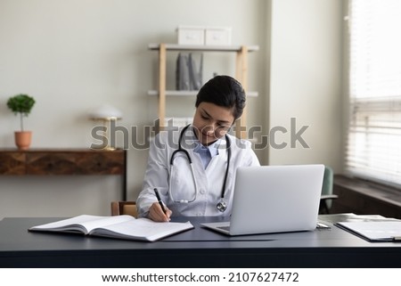 Similar – Image, Stock Photo Focused female making notes during psychotherapy session