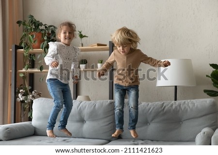Similar – Image, Stock Photo 2 children jumping on a bouncy cushion in the park