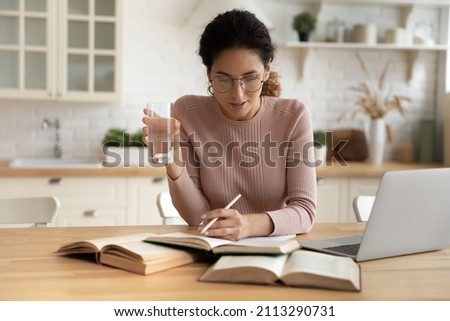 Similar – Image, Stock Photo Thoughtful woman taking notes in notebook in cafe