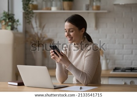 Similar – Image, Stock Photo Young businesswoman using smartphone and holding documents