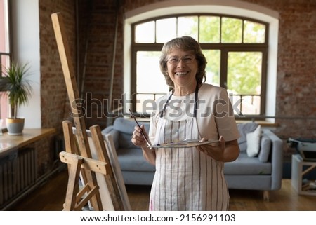 Similar – Image, Stock Photo Older woman painting on a notebook