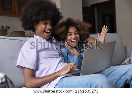 Similar – Image, Stock Photo Amazed girl making hairdo on dreadlocks of father