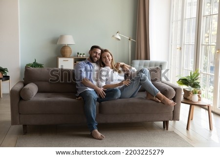 Similar – Image, Stock Photo Young couple resting on cozy sofa at home