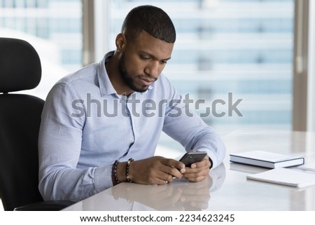 Similar – Image, Stock Photo Focused man using smartphone on rooftop