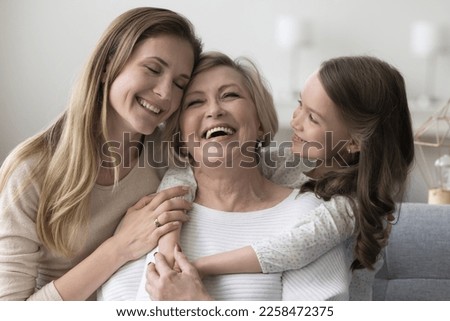 Similar – Image, Stock Photo Happy Joyful senior old white hair woman wearing santa claus hat smiling while using smart phone. stands against a color background. Wearing Christmas clothes. Copy space. Advertising space