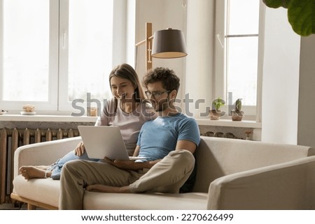 Similar – Image, Stock Photo Couple looking at laptop in kitchen.