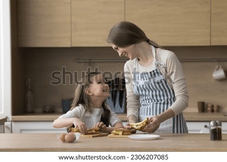 Similar – Foto Bild Kleine Tochter macht mit der Mutter zu Hause einen handgemachten Pompon