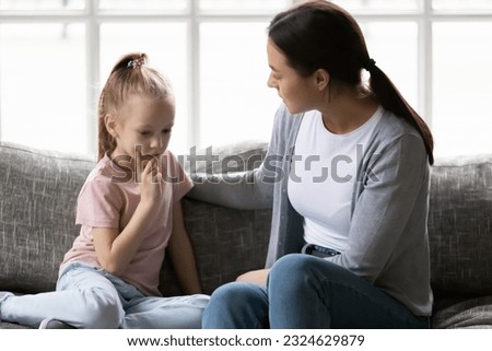 Similar – Image, Stock Photo Serious mother and kids spending time together using gadgets on sofa at home