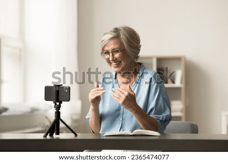 Image, Stock Photo Senior influencer working at table in modern workplace