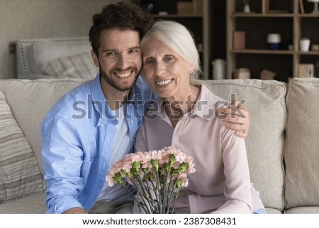 Similar – Image, Stock Photo Son hugging his mom and kissing her on the cheek