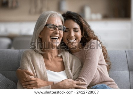 Similar – Image, Stock Photo Two happy affectionate young woman hugging each other in a close embrace while laughing and smiling, young multiracial female friends