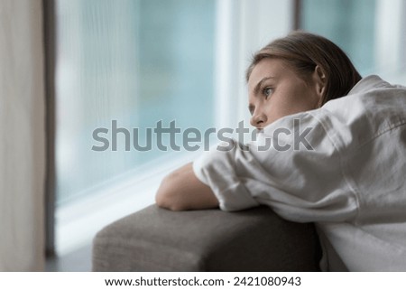 Similar – Image, Stock Photo Melancholic young woman looking through window