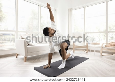 Similar – Image, Stock Photo Focused athletes practicing yoga together performing supported shoulderstand balance position in contemporary gym